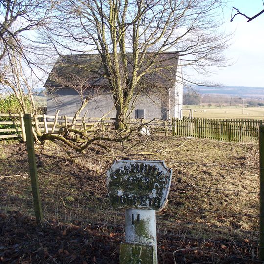 Milepost, Front Street, just N of B3645 jct, by telephone exchange enclosure
