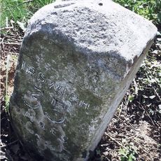 Milestone, 100 yds S of drive with double gates