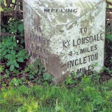 Milestone, Wrayton, 200m S of jct with bus shelter, leading to village