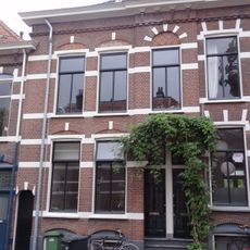 Rijtje van drie tweebeukige woonhuizen met elk een beneden- en een bovenwoning