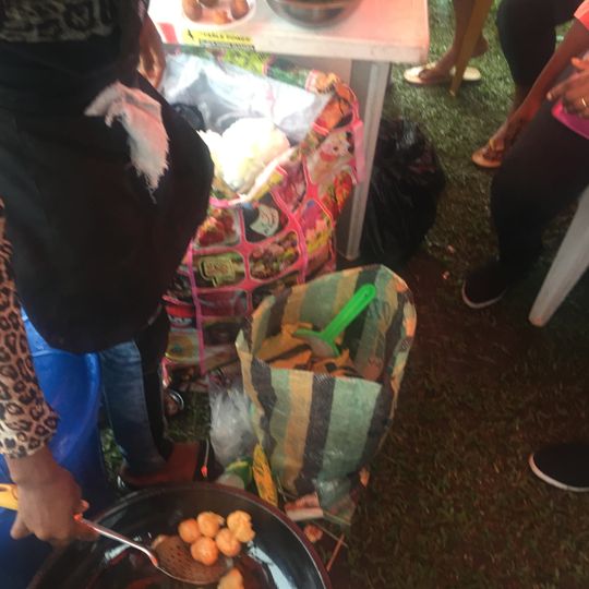 African Lady friying " BONS" for a local event