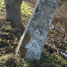 Milestone, N of entrance to School Farm, Chittering
