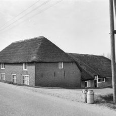 Boerderij, waarvan het woongedeelte dwars voor de stal is gebouwd. Woonhuis onder rieten schilddak. Vensters met 12-ruitsschuiframen
