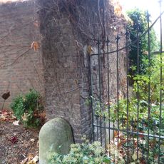 Huis met de trappen: brick and marl stone garden wall with masonry fence pillars