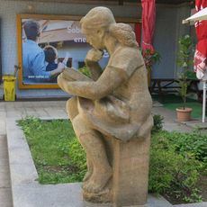 Socha dívky s knihou před spořitelnou v Seifertově ulici v Neštěmicích