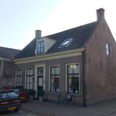 Dwarshuis van alleen beganegrond met empire-ramen en deurpartij met bovenlicht