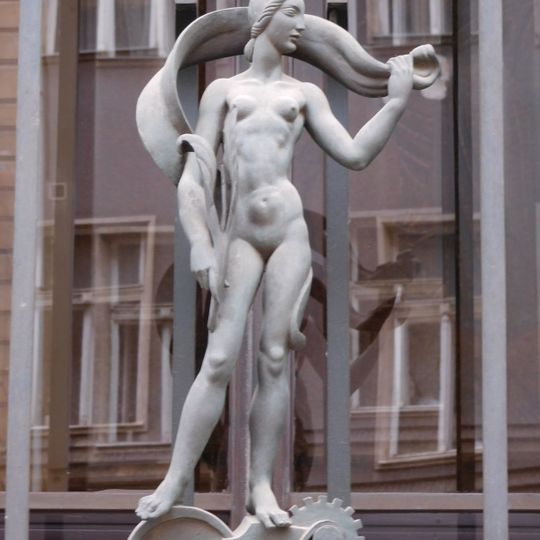 Statues of woman and man on the Tobacco Administration building