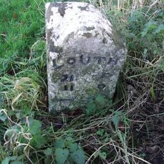 Milestone In Village Centre On South Side Of Road