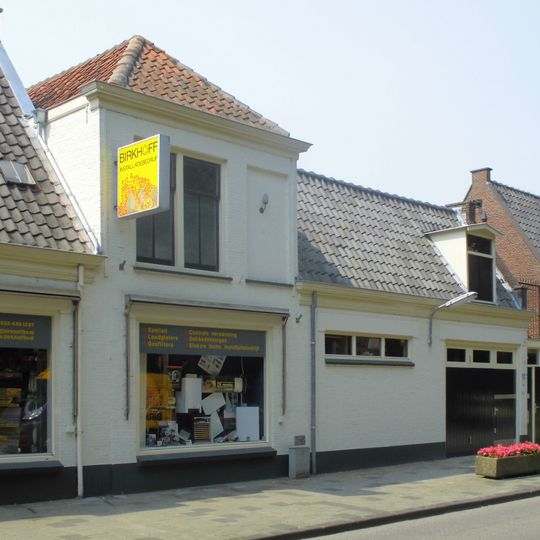 Pand zonder verdieping pand met gepleisterde door een lijst afgesloten lage gevel aan de straatzijde negenruits schuifvenster met luiken behangen