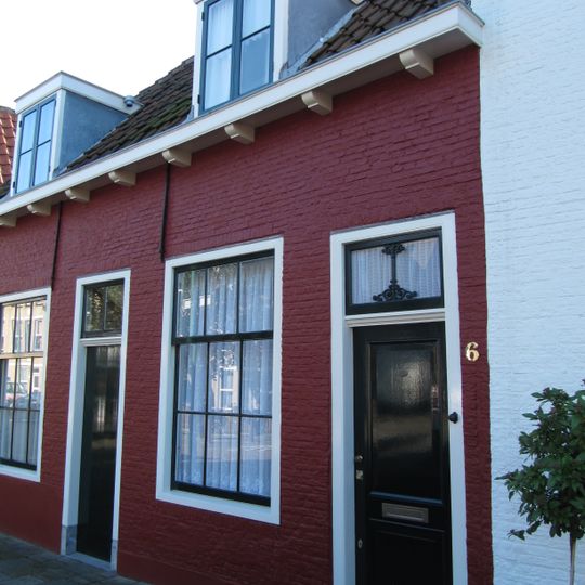 Pand zonder verdieping. Hoog schilddak met de nok evenwijdig aan de straat