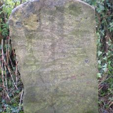 Milestone, by Naunton Farm Cottages by track