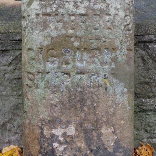 Milestone, Sawley Road, by Christ Church wall