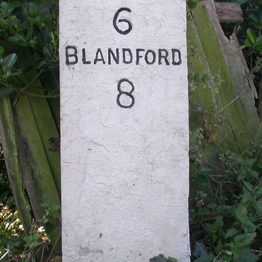 Milestone, 50m W of 'Coventry Arms' Pub, outside most westerly house in village