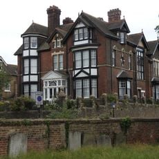 Wall With Gates Enclosing Churchyard Of St Margaret's Parish Church With Headstones Attached