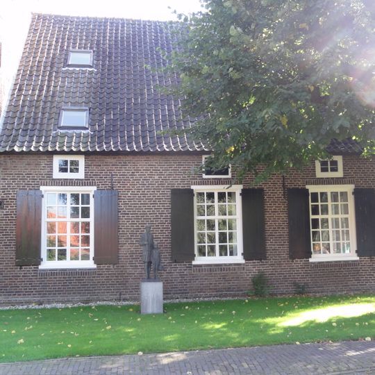 Het Smitshuis: klein gebouw, aansluitend bij het orgelmakershuis en met dezelfde, iets kortere ramen, waarboven kleine zoldervensters onder de rand van het met pannen belegd schilddak