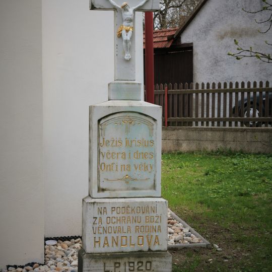 Wayside cross in Klokočí in front of a chapel