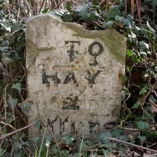 Milestone, Rock Coppice; 150m E Clifford turn against hedgerow