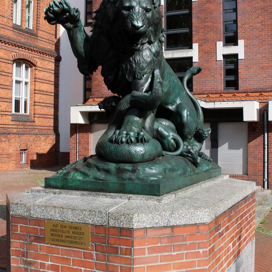 Lion with cubs strikes snake