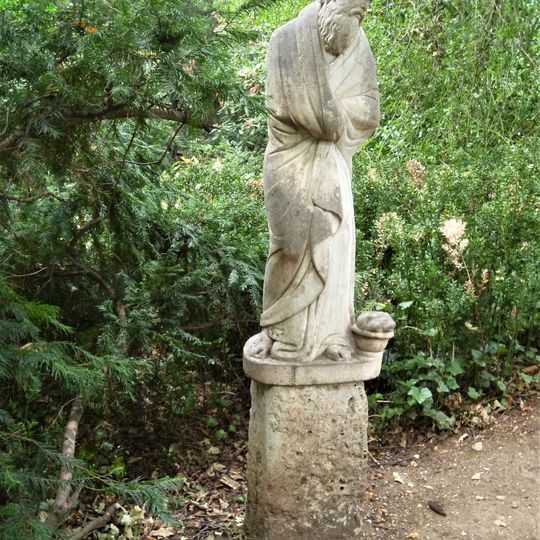 Figure Of Elderly Man In Poets Walk At Anglesey Abbey